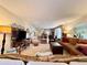 Spacious carpeted living room showing view into dining area and hallway, with comfortable furniture at 2630 Pearce Dr # 107, Clearwater, FL 33764