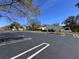 Spacious parking lot in front of community buildings featuring lovely landscaping and Spanish tile roofs at 2630 Pearce Dr # 107, Clearwater, FL 33764