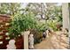 Landscaped patio with potted plants and brick wall, ideal for relaxation at 2630 Pearce Dr # 107, Clearwater, FL 33764