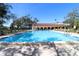 Beautiful community pool with clear blue water surrounded by lounge chairs and lush landscaping at 2630 Pearce Dr # 107, Clearwater, FL 33764