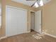 A carpeted bedroom features a closet, and a doorway with a door slightly ajar at 2910 Sunrise Dr, Clearwater, FL 33759