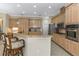 Open kitchen featuring light wood cabinets, stainless steel appliances and granite countertops at 2910 Sunrise Dr, Clearwater, FL 33759