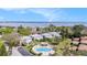 Aerial view of the community featuring a pool, landscaping, and building exteriors with a bridge in the distance at 2934 Lichen Ln # C, Clearwater, FL 33760