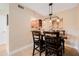 Dining room with a modern light fixture, a wooden table, and views of the kitchen at 2934 Lichen Ln # C, Clearwater, FL 33760