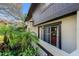 Exterior view with lush landscaping and sliding door access to the home at 2934 Lichen Ln # C, Clearwater, FL 33760