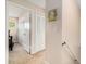 Hallway with closet space leading to a bedroom with light-colored carpet flooring at 2934 Lichen Ln # C, Clearwater, FL 33760