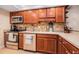 Well-equipped kitchen featuring stainless steel appliances and wooden cabinetry at 2934 Lichen Ln # C, Clearwater, FL 33760