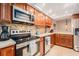 Modern kitchen with stone countertops, backsplash, stainless steel appliances, and wooden cabinets at 2934 Lichen Ln # C, Clearwater, FL 33760