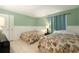 Bedroom featuring twin beds with floral comforters and paneled wall detail at 3600 42Nd S St # 52B, St Petersburg, FL 33711
