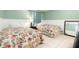 Bright bedroom featuring twin beds with floral comforters and lots of natural light at 3600 42Nd S St # 52B, St Petersburg, FL 33711