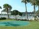 Community putting green surrounded by lush landscaping, pool, and shaded gazebo at 3600 42Nd S St # 52B, St Petersburg, FL 33711