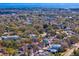 Overhead view displaying the property's placement in a leafy neighborhood with waterfront views in the distance at 3630 Foster Hill N Dr, St Petersburg, FL 33704