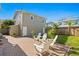 Cozy backyard with brick patio, white chairs, and a wooden fence at 3630 Foster Hill N Dr, St Petersburg, FL 33704