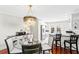 Dining area featuring a glass table, wood chairs, and a modern chandelier, next to a black countertop bar at 3630 Foster Hill N Dr, St Petersburg, FL 33704