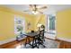 Home office featuring wood floors, ceiling fan, work desk, and sunlit window at 3630 Foster Hill N Dr, St Petersburg, FL 33704