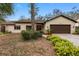 Charming single-story home with a well-manicured lawn and inviting curb appeal at 365 Mayfair E Cir, Palm Harbor, FL 34683