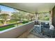Outdoor balcony featuring neutral furniture and views of the lush greenery at 36750 Us Highway 19 N # 6-214, Palm Harbor, FL 34684
