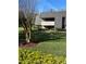 Well-maintained building with lush green lawn and manicured landscaping at 36750 Us Highway 19 N # 6-214, Palm Harbor, FL 34684