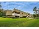 View of multi-Gathering residential building with well-maintained landscaping, walkways and outdoor living space at 36750 Us Highway 19 N # 6-214, Palm Harbor, FL 34684