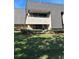 View of condo exterior highlights siding, brick accents, balcony and landscaping at 36750 Us Highway 19 N # 6-214, Palm Harbor, FL 34684