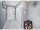 Hallway with neutral colored walls, tiled floor, closet, and door with security features and peephole at 36750 Us Highway 19 N # 6-214, Palm Harbor, FL 34684