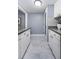 Bright kitchen featuring granite countertops, white cabinets, and modern tile flooring, creating a clean and functional space at 36750 Us Highway 19 N # 6-214, Palm Harbor, FL 34684