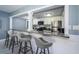 Open-concept kitchen with a breakfast bar, granite countertops, stainless steel appliances, and a seamless connection to the living area at 36750 Us Highway 19 N # 6-214, Palm Harbor, FL 34684