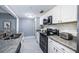 Updated kitchen with stainless steel appliances, granite countertops, stylish backsplash, and easy access to living spaces at 36750 Us Highway 19 N # 6-214, Palm Harbor, FL 34684
