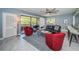 Bright living room featuring tile floors, large windows, and comfortable seating at 36750 Us Highway 19 N # 6-214, Palm Harbor, FL 34684