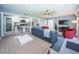 Open-concept living area with bar seating, tile flooring, and modern kitchen access at 36750 Us Highway 19 N # 6-214, Palm Harbor, FL 34684