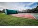 Outdoor racquetball court with a green wall and fenced area for play at 36750 Us Highway 19 N # 6-214, Palm Harbor, FL 34684
