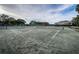 A clean, well-maintained tennis court with green surface and covered shelter under a bright, sunny sky at 36750 Us Highway 19 N # 6-214, Palm Harbor, FL 34684