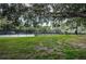 Serene view of well-kept tennis courts framed by lush greenery and shady trees at 36750 Us Highway 19 N # 6-214, Palm Harbor, FL 34684