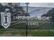 Sign on fence at Innisbrook tennis facilities with community logo and Innisbrook Tennis text at 36750 Us Highway 19 N # 6-214, Palm Harbor, FL 34684