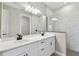 Bathroom showcasing a double vanity with marble countertop and large mirror with marble shower at 3681 Nandina Cir, Sun City Center, FL 33573