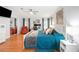A well-lit bedroom boasts wood floors, a large window, and a spacious feel with office and relaxation areas at 36838 Tara Ave, Zephyrhills, FL 33542