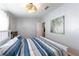 Bedroom with view of door and artwork, light fixture, wood floors, and a comfortable layout with bed at 36838 Tara Ave, Zephyrhills, FL 33542