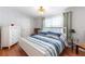 Inviting bedroom with light fixtures, wooden floors, and a comfortable layout with dresser at 36838 Tara Ave, Zephyrhills, FL 33542