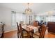 This dining room has a wooden table and six chairs, as well as a modern chandelier at 36838 Tara Ave, Zephyrhills, FL 33542
