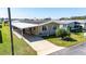 This lovely single Gathering features a neutral exterior, carport, driveway, and well-manicured lawn at 36838 Tara Ave, Zephyrhills, FL 33542