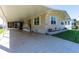 Welcoming exterior with a covered carport, a well-manicured lawn, and a charming facade with shuttered windows at 36838 Tara Ave, Zephyrhills, FL 33542