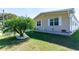 Beautiful home exterior with lush green lawn, palm tree accent, and neutral-colored siding at 36838 Tara Ave, Zephyrhills, FL 33542
