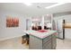 Open-concept kitchen with a center island, stainless steel refrigerator, and views into the dining and living areas at 36838 Tara Ave, Zephyrhills, FL 33542