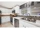 Modern kitchen showcasing stainless steel appliances, tile backsplash, and a double-basin sink with contemporary fixtures at 36838 Tara Ave, Zephyrhills, FL 33542