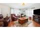 A welcoming living room with plush leather seating, a wooden coffee table, and abundant natural light at 36838 Tara Ave, Zephyrhills, FL 33542