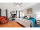 Main bedroom with a ceiling fan, white furniture, and a work desk with two monitors at 36838 Tara Ave, Zephyrhills, FL 33542