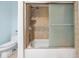 Shower and bathtub combo with sliding glass door and tile surround at 4383 Biscayne Dr, Hernando Beach, FL 34607