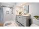 Modern bathroom features a walk-in shower, double vanity, and a neutral color scheme at 4383 Biscayne Dr, Hernando Beach, FL 34607