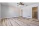 Bright bedroom features stylish laminate wood flooring, ceiling fan, and closet at 4383 Biscayne Dr, Hernando Beach, FL 34607