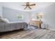 Bright bedroom with wood-look floors, ceiling fan, and natural light at 4383 Biscayne Dr, Hernando Beach, FL 34607